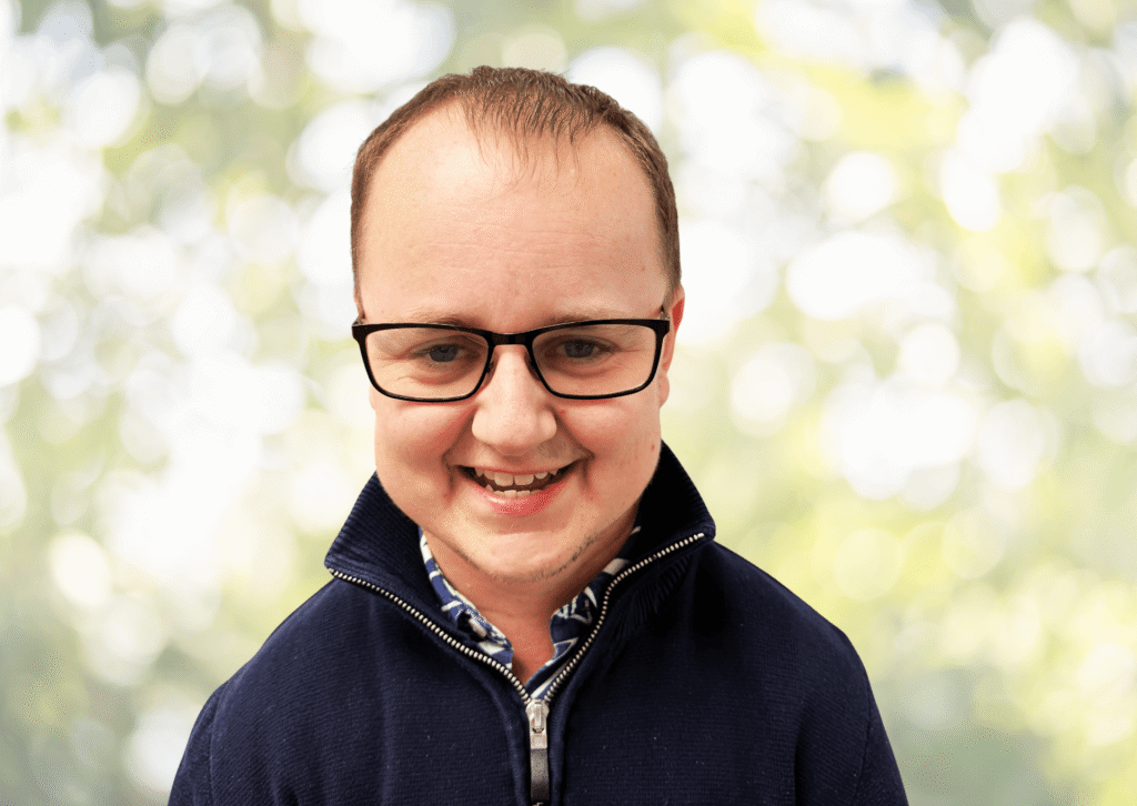 Adam Garraway from the PFM Associates team, smiling in an outdoor headshot
