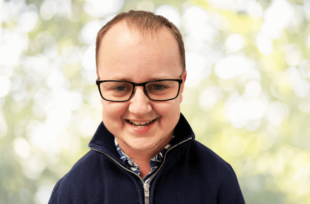 Adam Garraway from the PFM Associates team, smiling in an outdoor headshot