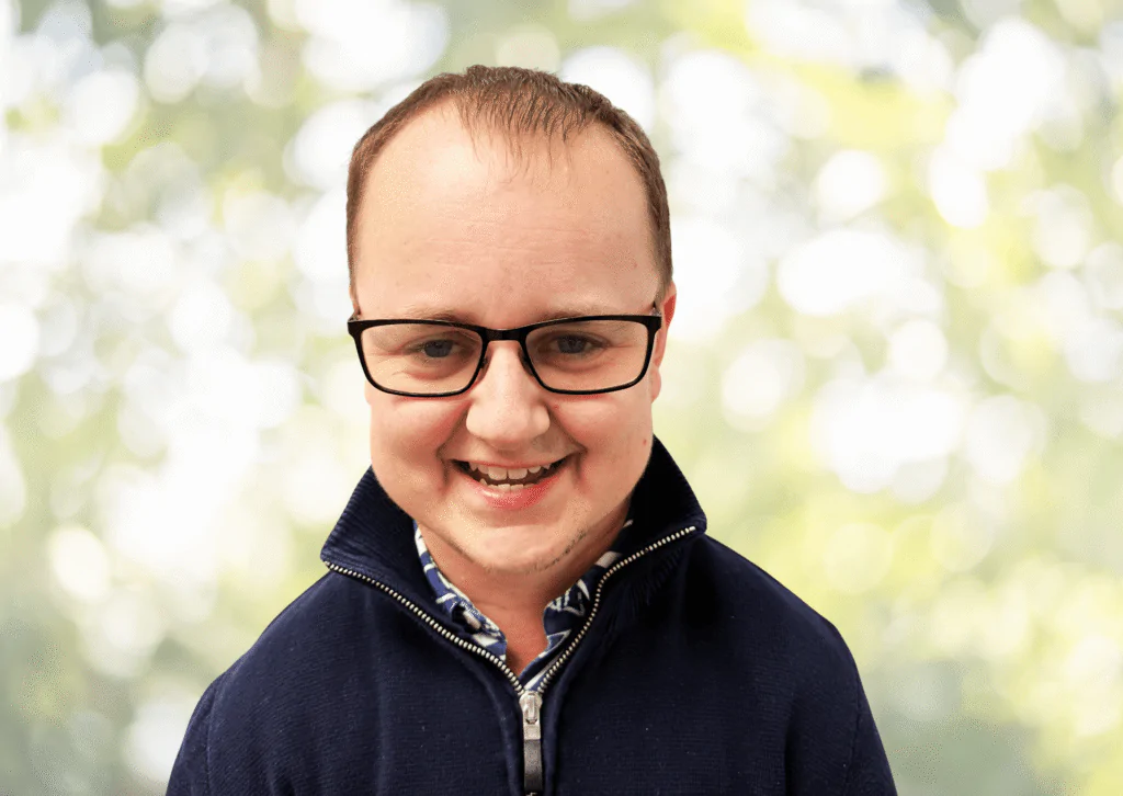 Adam Garraway from the PFM Associates team, smiling in an outdoor headshot